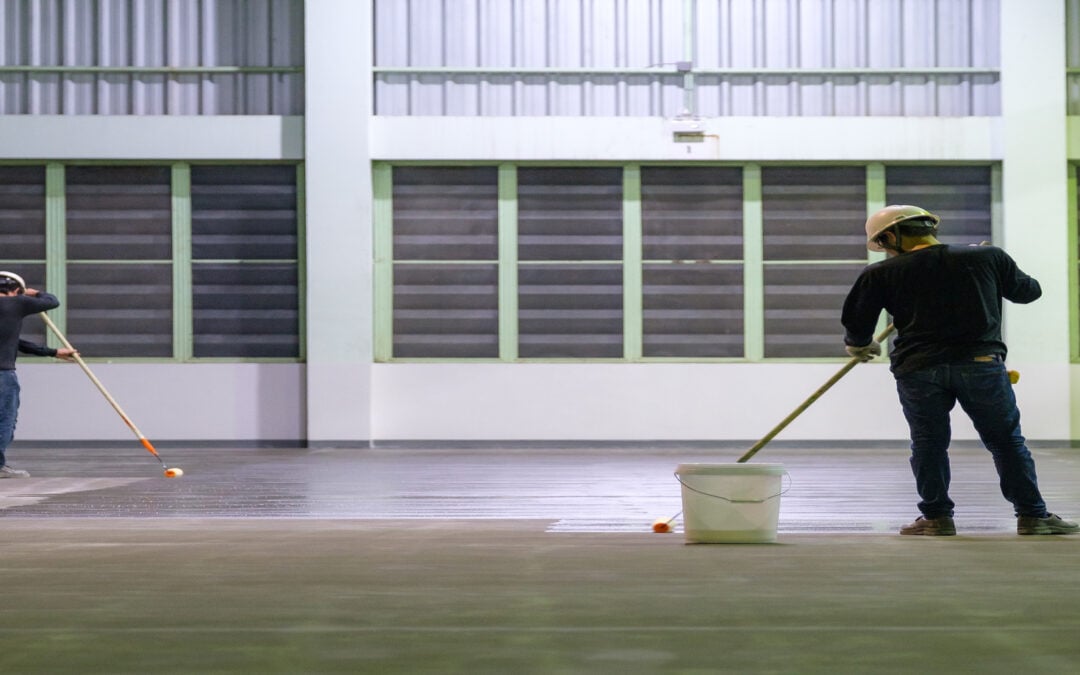 Construction workers polishing industrial concrete surface